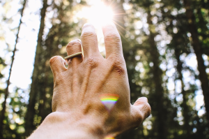 Energy-healing Person’s hand pointed towards sunlight